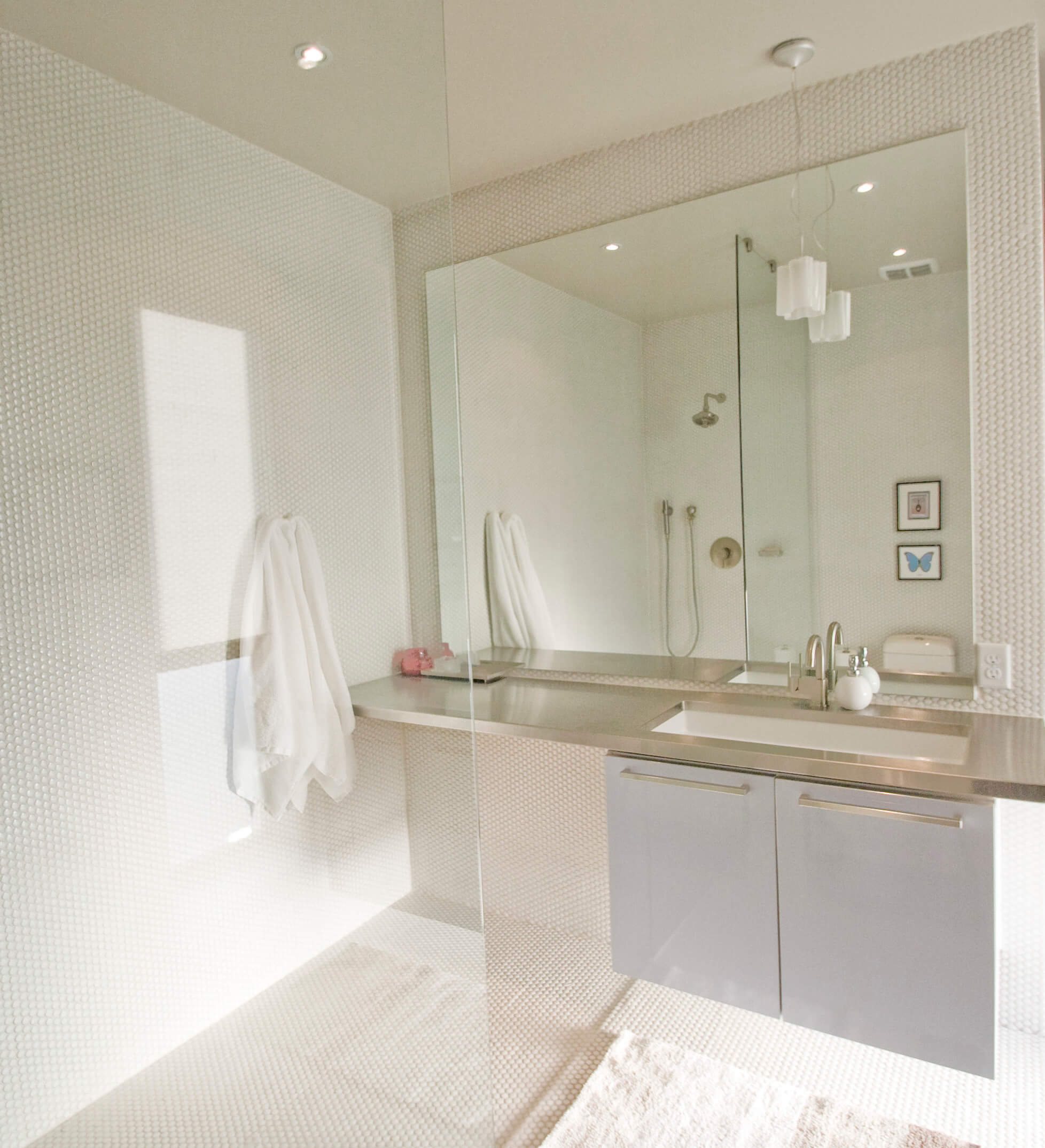 A bathroom with a large mirror and sink.